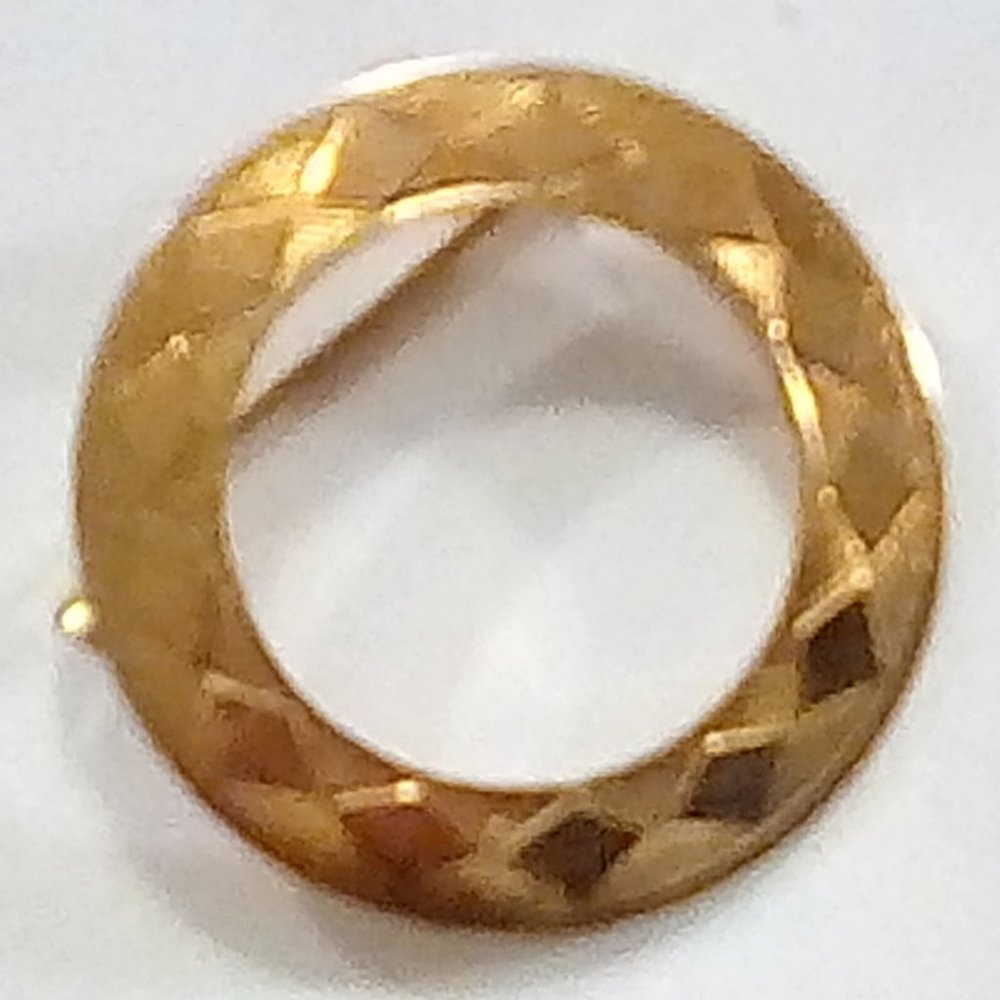 Gold color circular brooch